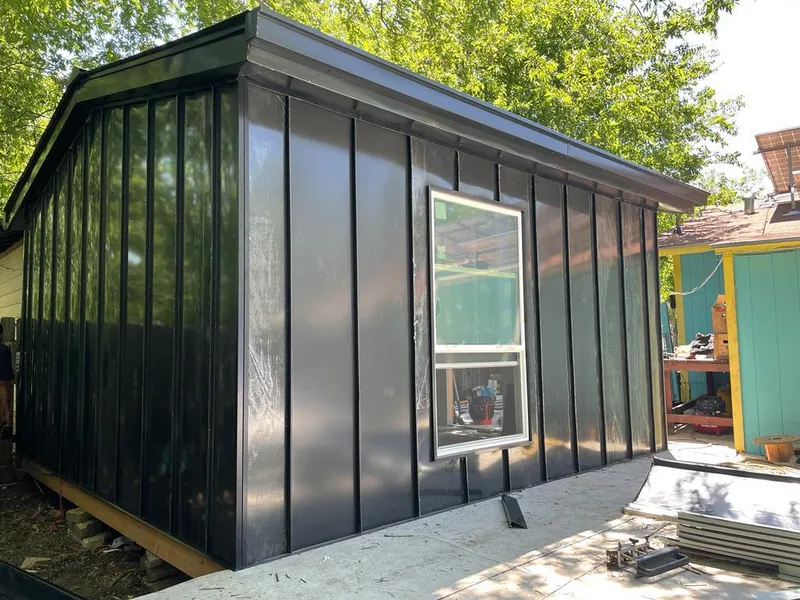 Black standing seam metal wall panels for Metal Roof Installation in The Pinery